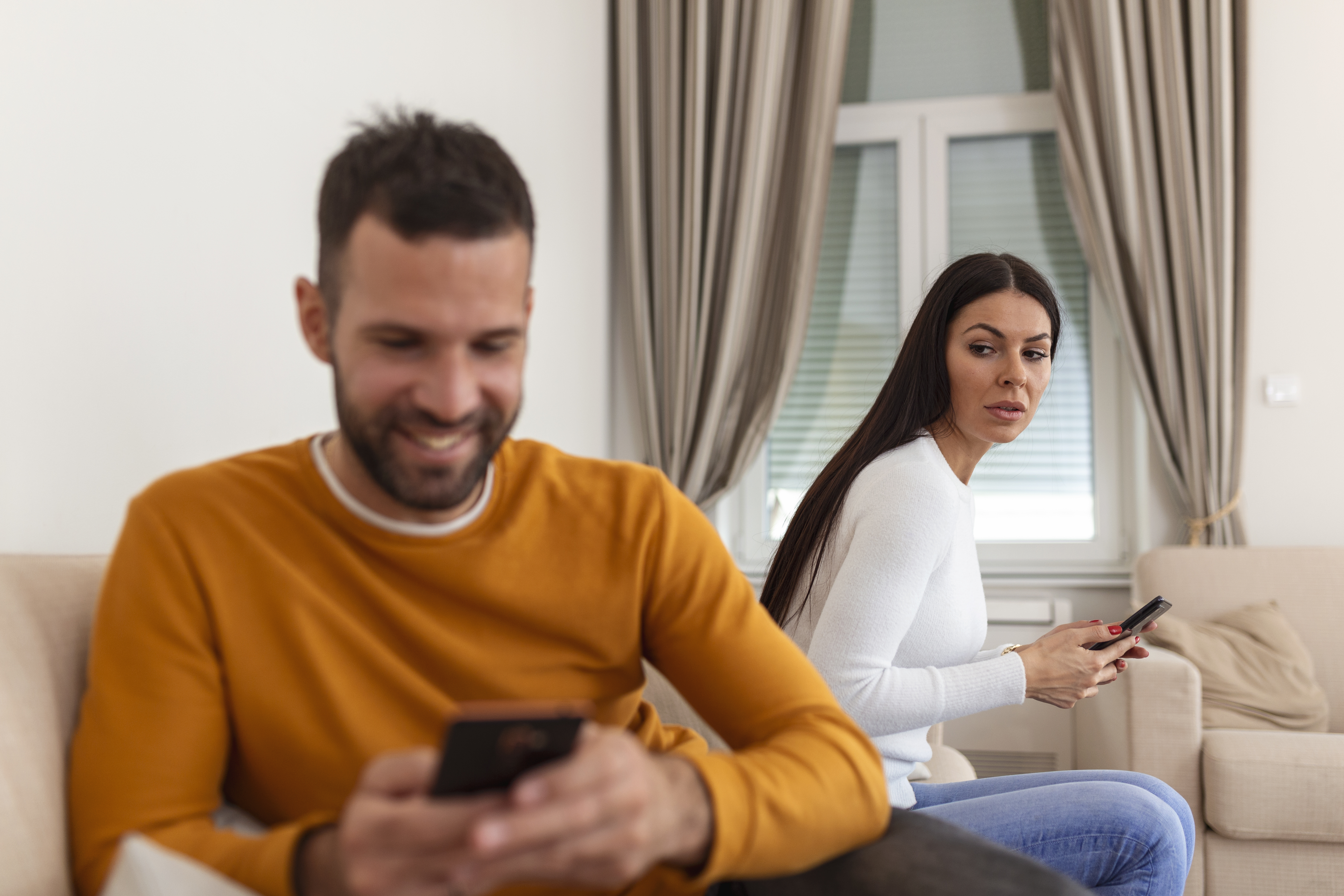 1707503726719-jealous-suspicious-mad-wife-arguing-with-obsessed-husband-holding-phone-texting-cheating-cellphone-distrustful-girlfriend-annoyed-with-boyfriend-mobile-addiction-distrust-social-media-dependence.jpg